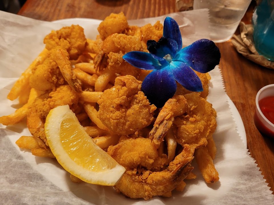 Cajun seafood plates on a lively restaurant table.