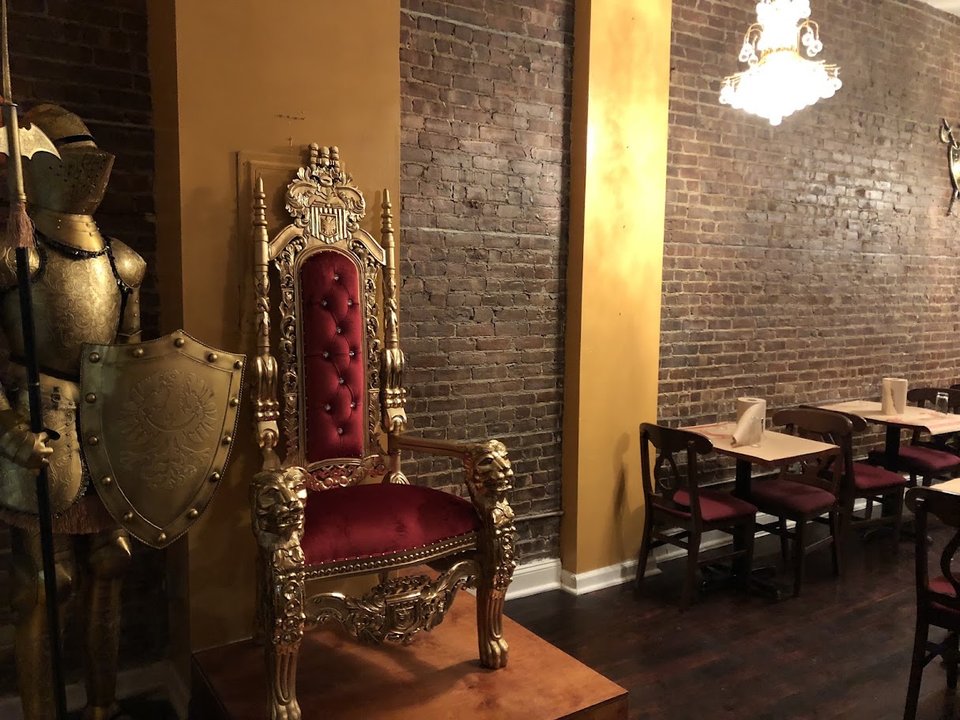 Warm dining room with bar seating and soft lighting.